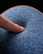 Macro of a finger pressing into the memory foam showing slow rebound