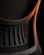 Macro of the breathable black mesh backrest weave on the office chair