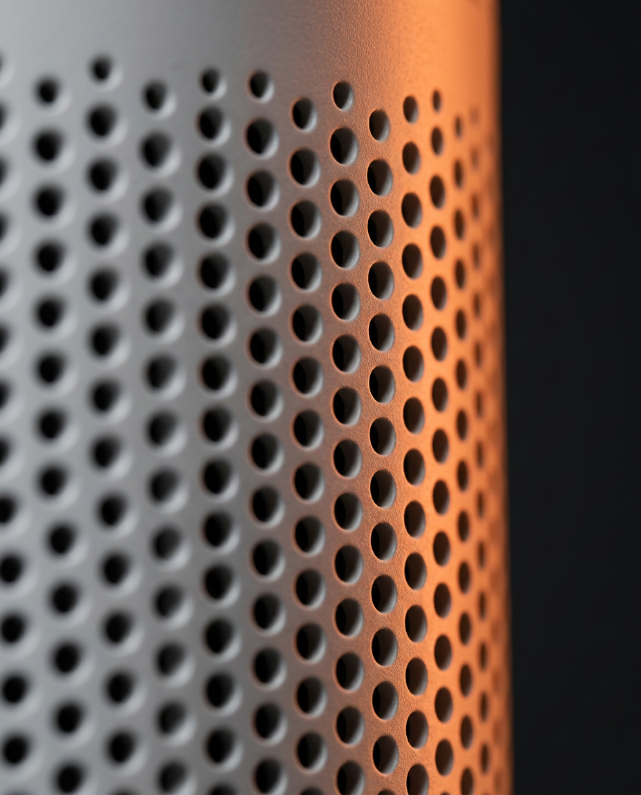 Macro of the perforated mesh air intake vents on the purifier