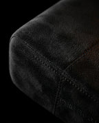 Macro of the soft black microfiber cover and stitched seam of the foot rest