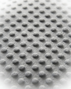 Macro of the soft grey minky raised-dot fabric on the weighted cushion