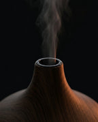 Macro of mist rising from the top aperture of the wood-grain diffuser
