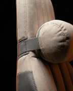 Macro of detachable neck pillow with adjustable strap on bed support