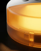Macro of the warm amber nightlight glow on the sleep machine base