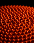 Macro of the raised massage nubs covering the orange balance cushion surface