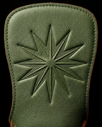 Macro of the embossed starburst grip pattern on green leather palm pad