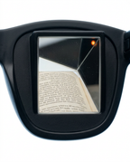 Macro of the angled prism lens reflecting an open book's text
