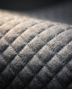 Macro of the gray quilted diamond-stitch cover fabric