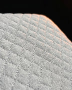 Macro of the diamond-quilted knit fabric cover on the memory foam wedge