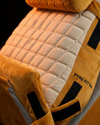 Macro of quilted velvet stitching texture on yellow wedge pillow