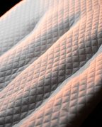 Macro of the quilted knit top surface of the leg elevation pillow