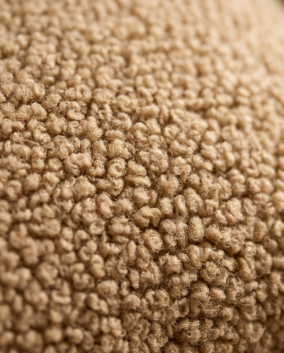 Macro close-up of the plush boucle sherpa fleece on the lumbar pillow