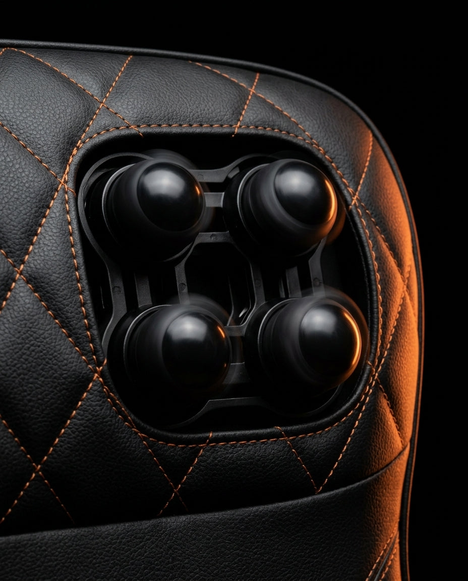 Macro of the four rotating shiatsu massage nodes set into quilted black leather
