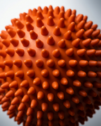Top-down macro of the dense orange spikes covering the massage ball