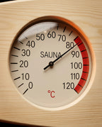Macro of sauna thermometer dial with red comfort zone, 0-120 Celsius