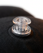 Macro close-up of the clear dual air valve on the travel footrest pillow