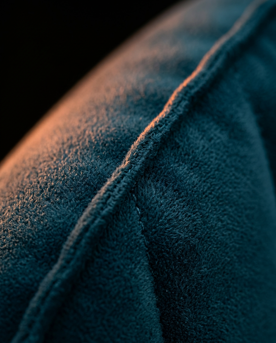 Macro of the soft velvet flocking and seam on the navy travel wedge pillow