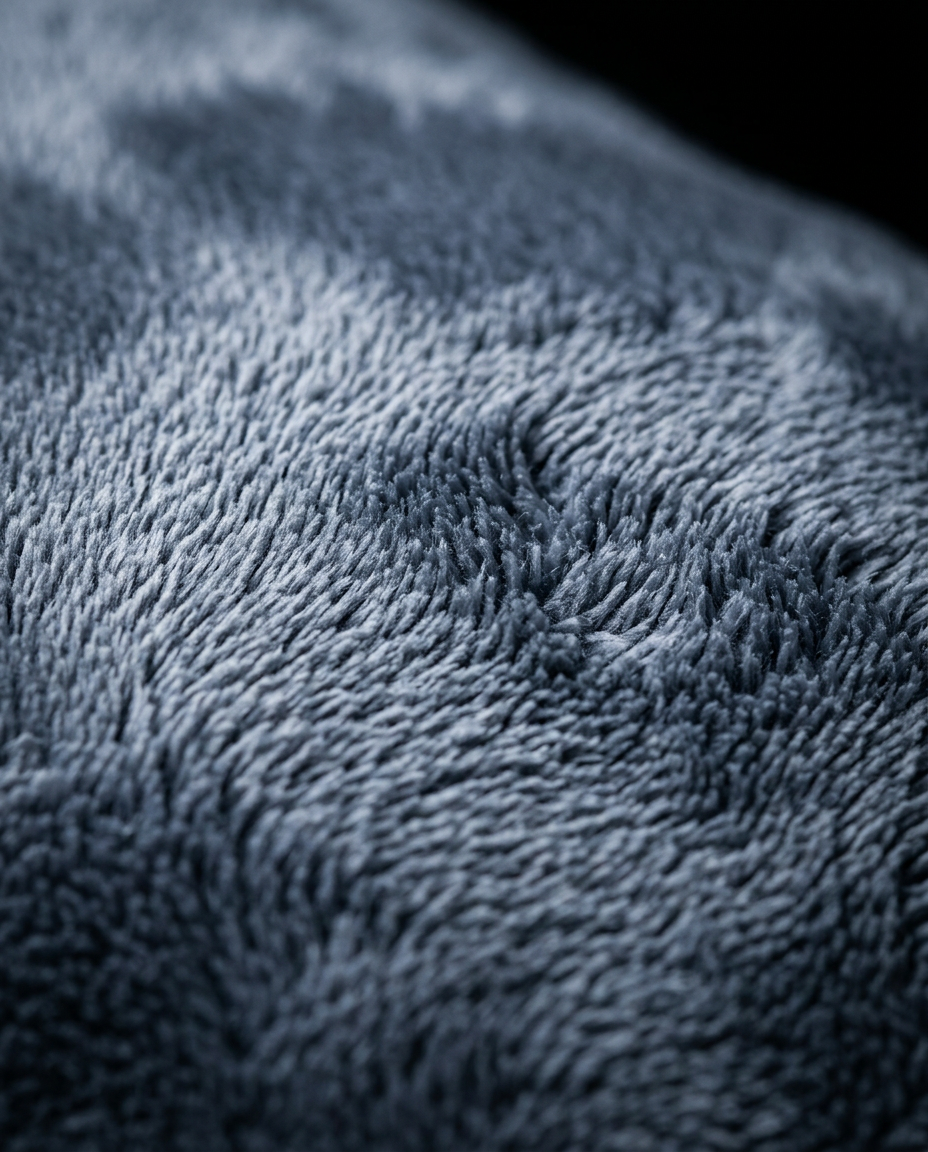 Macro close-up of the soft grey velvet pile of the heel cushion