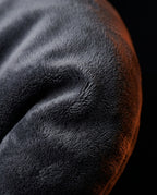 Macro close-up of the soft grey velvet cover of the body pillow