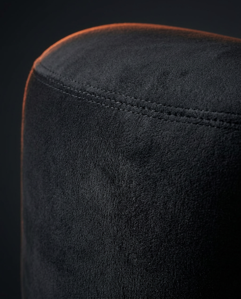 Macro of the soft black velvet surface and seam of the meditation bolster