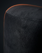 Macro of the soft black velvet surface and seam of the meditation bolster