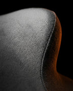 Macro close-up of the soft grey velvet fabric surface and seam of the support pillow