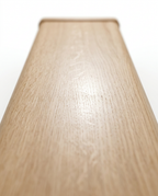 Macro of the smooth natural wood grain along the balance beam surface