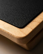 Macro of the maple wood grain edge and textured non-slip pad of the balance board