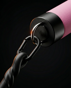 Close-up of pink bar end cap with carabiner clip and resistance band