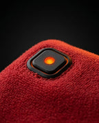 Close-up of the heated scarf's power button glowing orange on red fleece