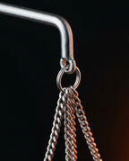 Close-up of stainless steel chain ring and arm on hanging oil bowl