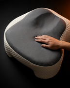 Hand pressing into the grey mesh contoured top of the side sleeper pillow