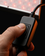 Hand pressing the one-touch inline controller switch of the red light panel