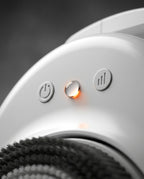 Macro of the shower scrubber's control buttons with glowing power and speed lights