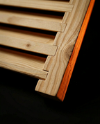 Macro of the corner joinery where the slats meet the sauna grille frame