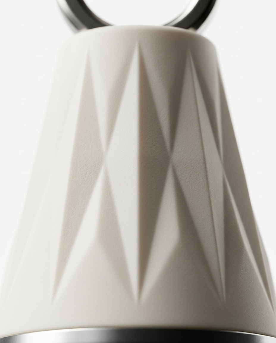 Macro detail of the faceted diamond-textured cream body of the face massage tool