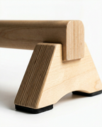 Macro of the balance bar's plywood end leg with non-slip rubber feet