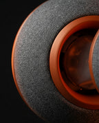 Macro of the woven grey knit fabric and orange trim ring of the neck pillow