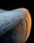 Close-up of the pillow's plush cover fabric and breathable mesh side panel