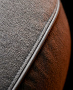 Macro of the grey knit fabric weave and piped seam of the feeding pillow