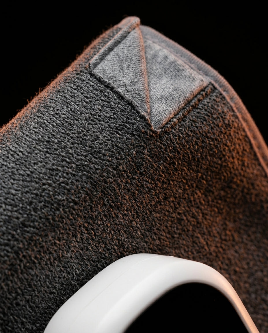 Macro close-up of the soft grey fabric weave and stitching of the wrap