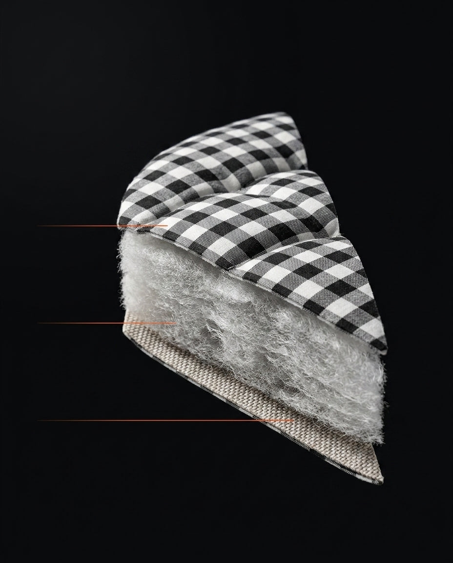 Cross-section of the mattress showing checkered cover, fiber fill and woven base
