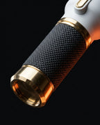 Close-up of the knurled handle grip and polished gold end cap