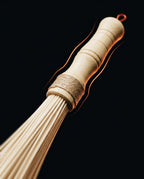 Macro of the turned wooden handle and twine binding of the bamboo roller
