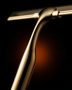 Macro of the curved ergonomic polished brass squeegee handle and head