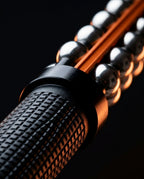 Close-up of the diamond-knurled black handle grip on the muscle roller
