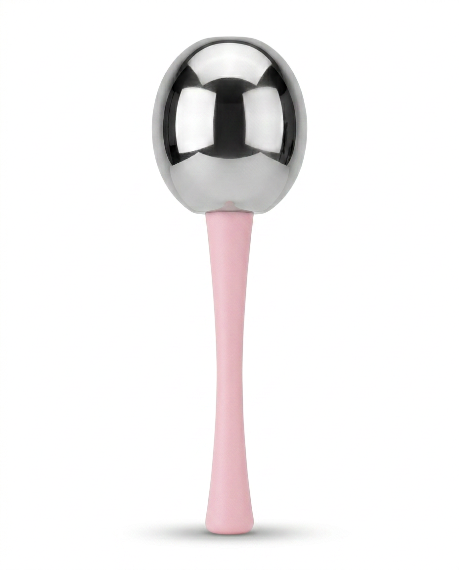 Macro of a single roller's steel ball head and contoured pink silicone handle