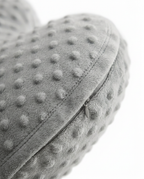 Close-up of the stitched seam along the edge of the heart cushion
