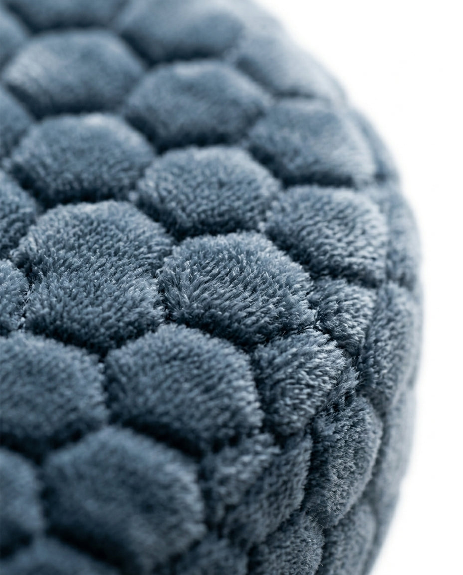 Macro of the plush honeycomb velvet cover on the grey ear pillow