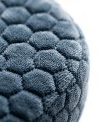 Macro of the plush honeycomb velvet cover on the grey ear pillow